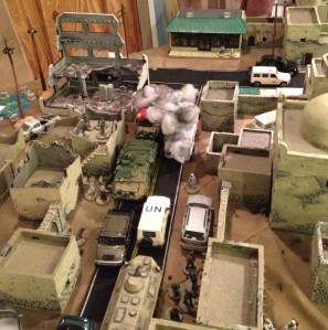 28mm American armored vehicle takes a rocket launcher attack in the rear from Sunni troops hidden in convenience store.  UN troops at bottom of photo preparing to breech wall and enter Mosque compound.  